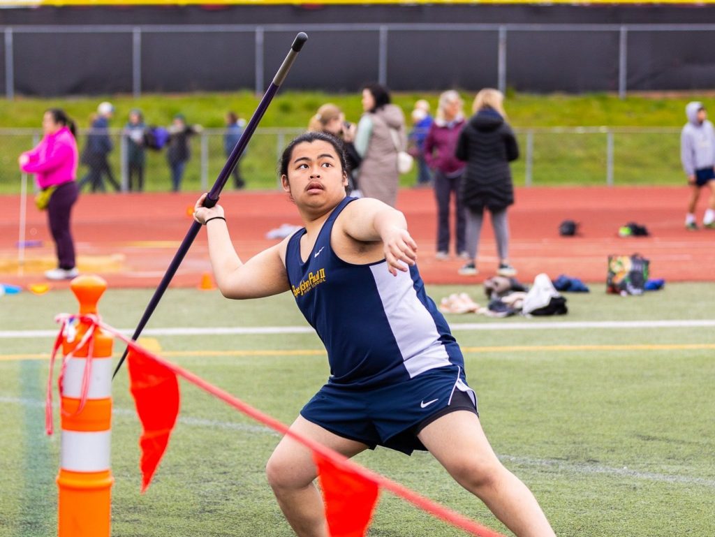 A male track & field athlete prepares to throw a javelin.