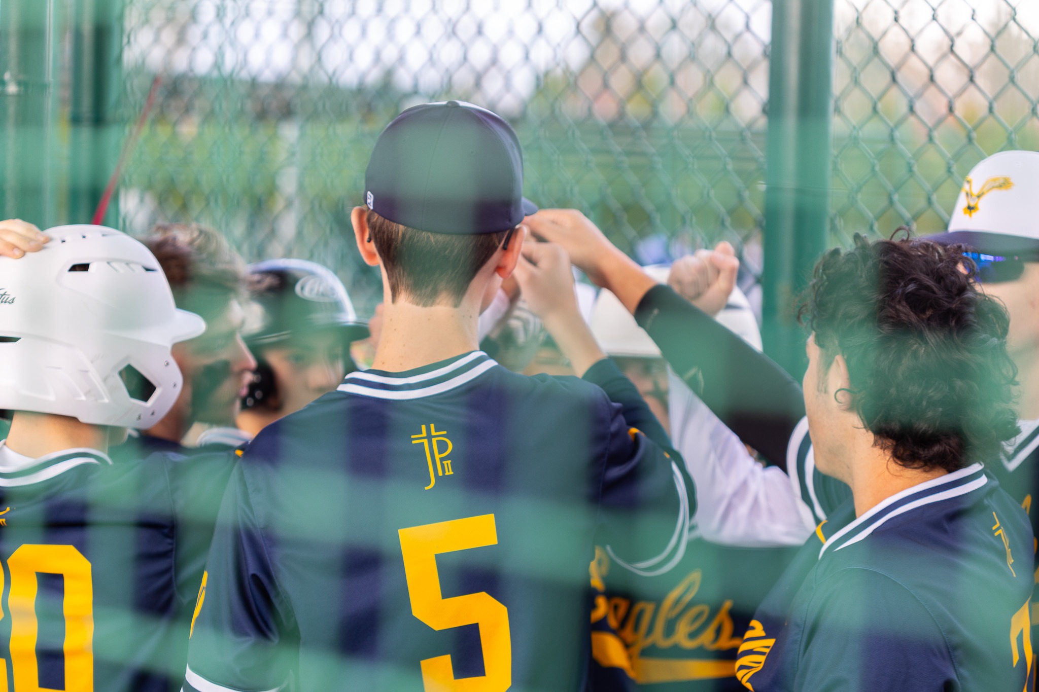 The baseball team in a huddle.