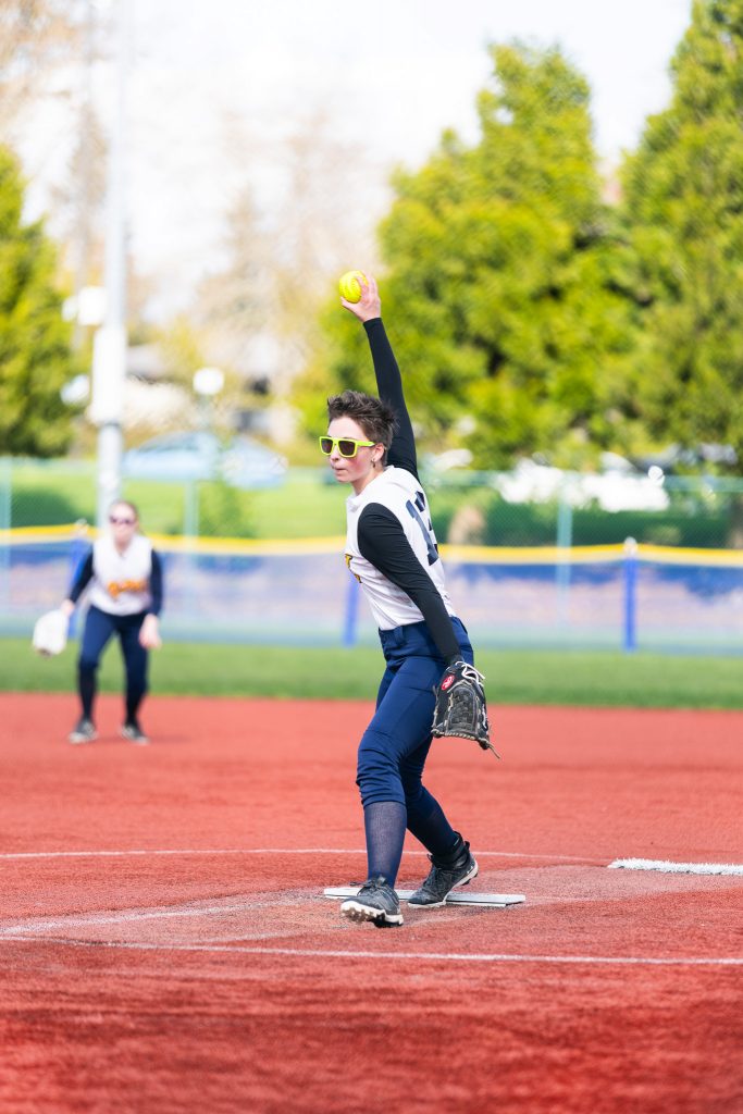 Fastpitch athlete pitching.