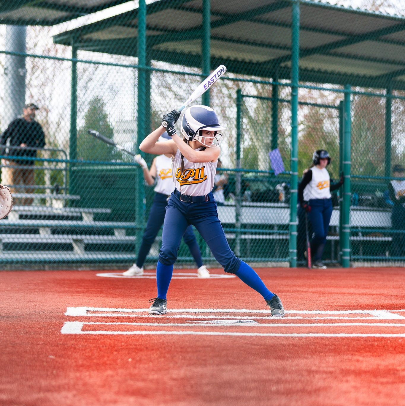 Fastpitch athlete batting.