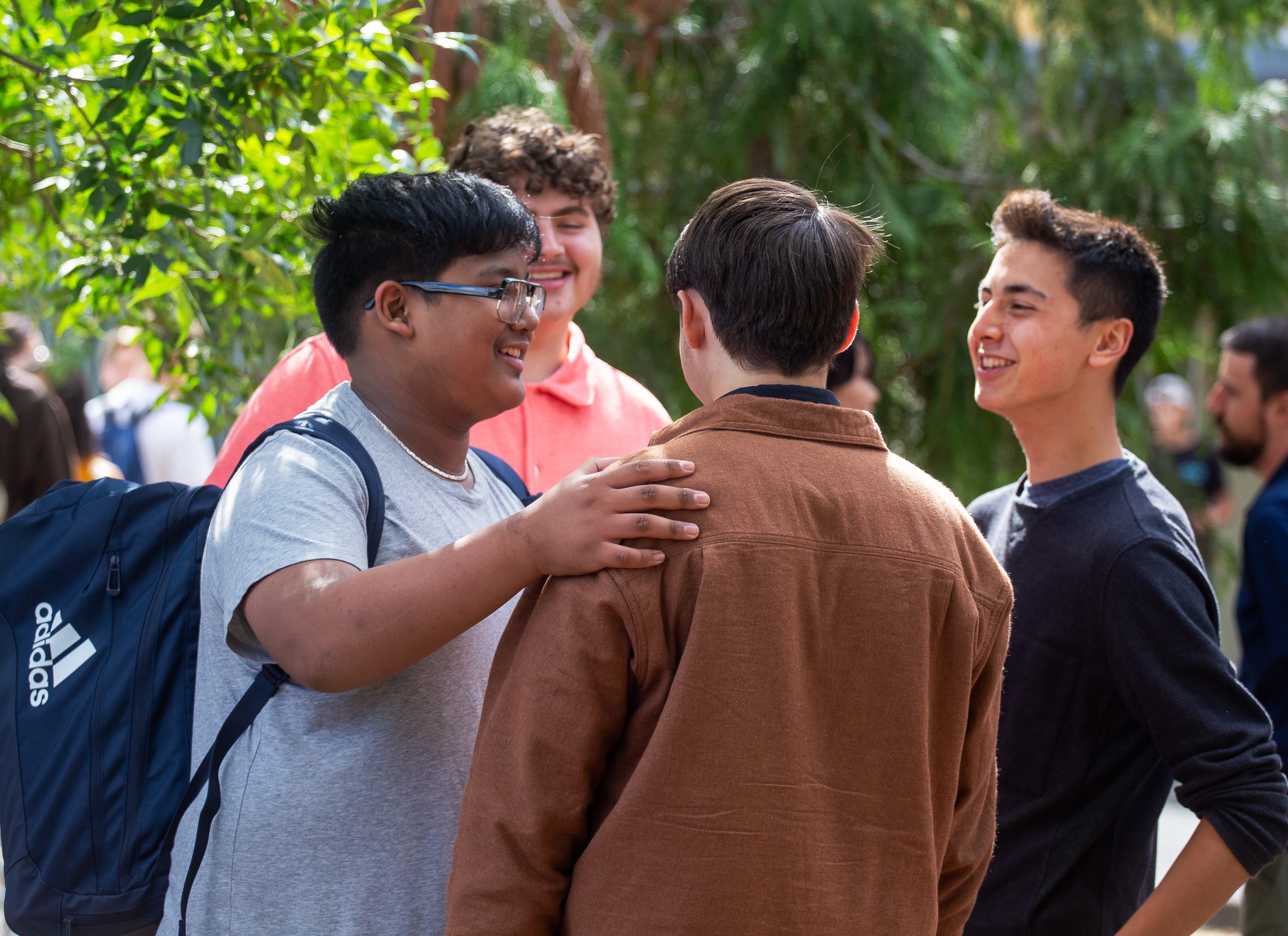Male students laugh together on campus.